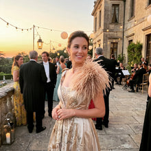 Load image into Gallery viewer, A glamorous woman wearing a champagne sandy ostrich feather brooch on her evening dress at a reception