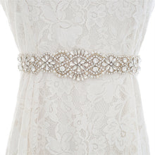 Load image into Gallery viewer, Art Deco inspired rhinestone bridal belt with a prominent center crystal, accessorized on a wedding dress.