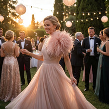 Load image into Gallery viewer, A close-up of a guest wearing a romantic blush pink ostrich feather brooch at a sunset wedding party