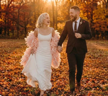 Load image into Gallery viewer, Blush pink ostrich feather shawl, lifestyle shot of the feather cape paired with a wedding dress for romantic photos