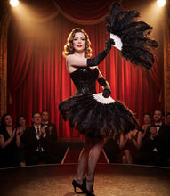 Load image into Gallery viewer, Black burlesque feather fans held by a performer on a vintage stage