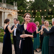 Load image into Gallery viewer, A woman styled in a vibrant fuchsia pink ostrich feather brooch for a formal cocktail party