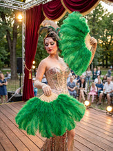 Load image into Gallery viewer, A performer holding a large emerald green ostrich feather fan on stage