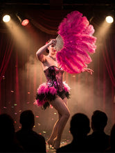 Load image into Gallery viewer, Hot pink ostrich feather fan held by a burlesque dancer on stage