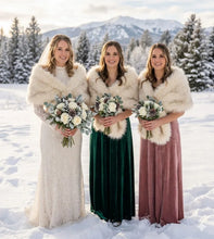 Load image into Gallery viewer, Bridesmaids holding bouquets in a snowy landscape, wearing elegant ivory faux fur bridal wraps over their dresses.
