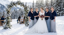 Load image into Gallery viewer, Wedding party posing in the snow with the bride and bridesmaids wearing navy blue faux fur wraps.