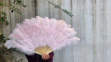 Load image into Gallery viewer, Pink feathered fan held by a person against a wooden background