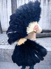 Load image into Gallery viewer, Oversized black ostrich feather fan in use, large fluffy fan for stage shows, festivals and burlesque performances