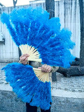 Load image into Gallery viewer, Turquoise blue ostrich feather fan in use, cool-toned fan for stage performances, festivals and parties