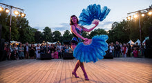 Load image into Gallery viewer, A dancer in a matching costume performing outdoors with turquoise ostrich feather fans.