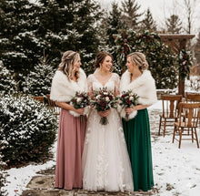 Load image into Gallery viewer, Three bridesmaids in forest green dresses wearing white faux fur stoles with brown tips for a winter wedding.