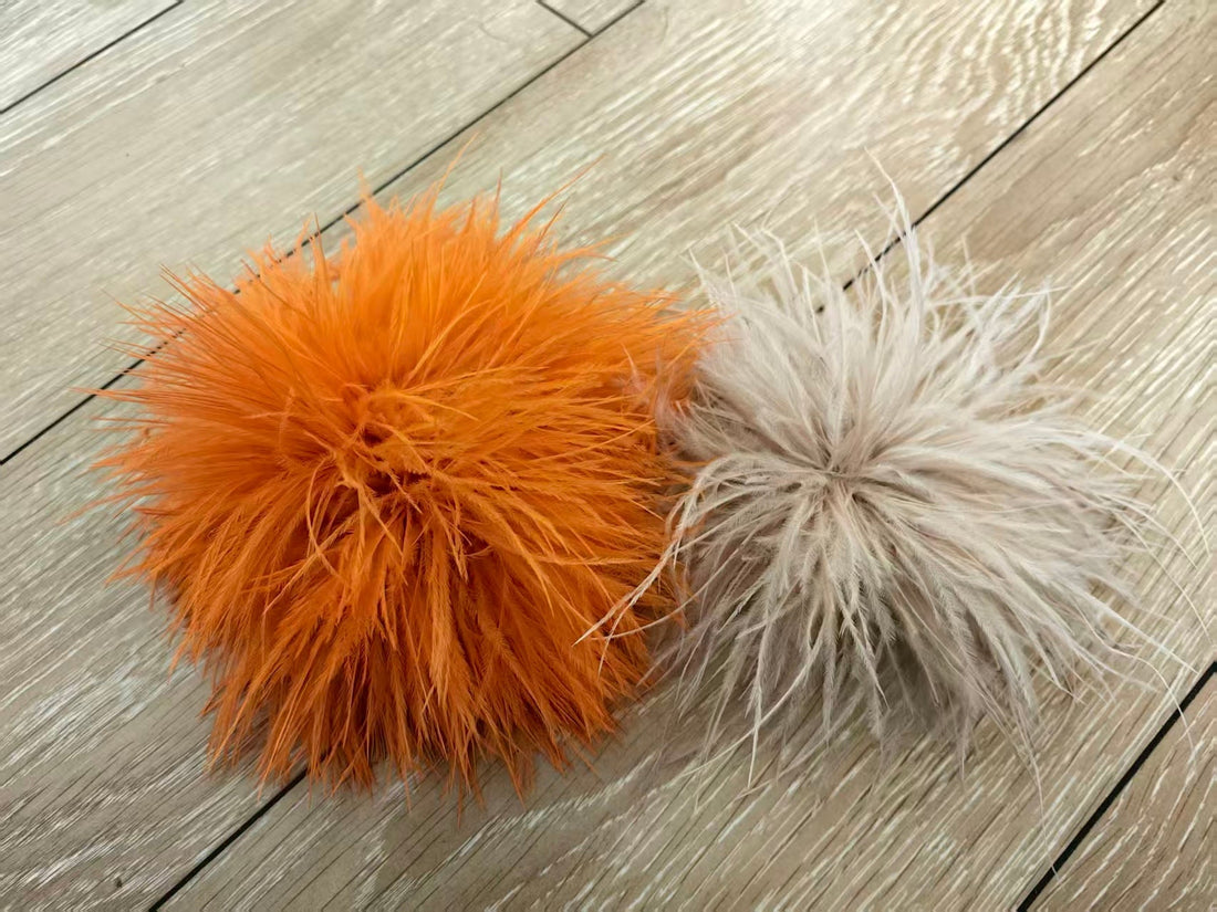 Side‑by‑side comparison of two ostrich feather brooch pins: our 20cm full‑volume brooch vs competitor 18cm sparse feather brooch