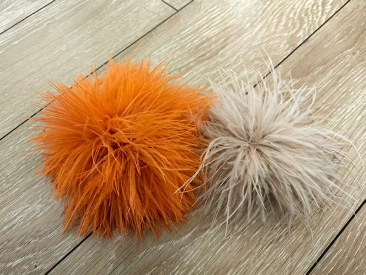Side‑by‑side comparison of two ostrich feather brooch pins: our 20cm full‑volume brooch vs competitor 18cm sparse feather brooch