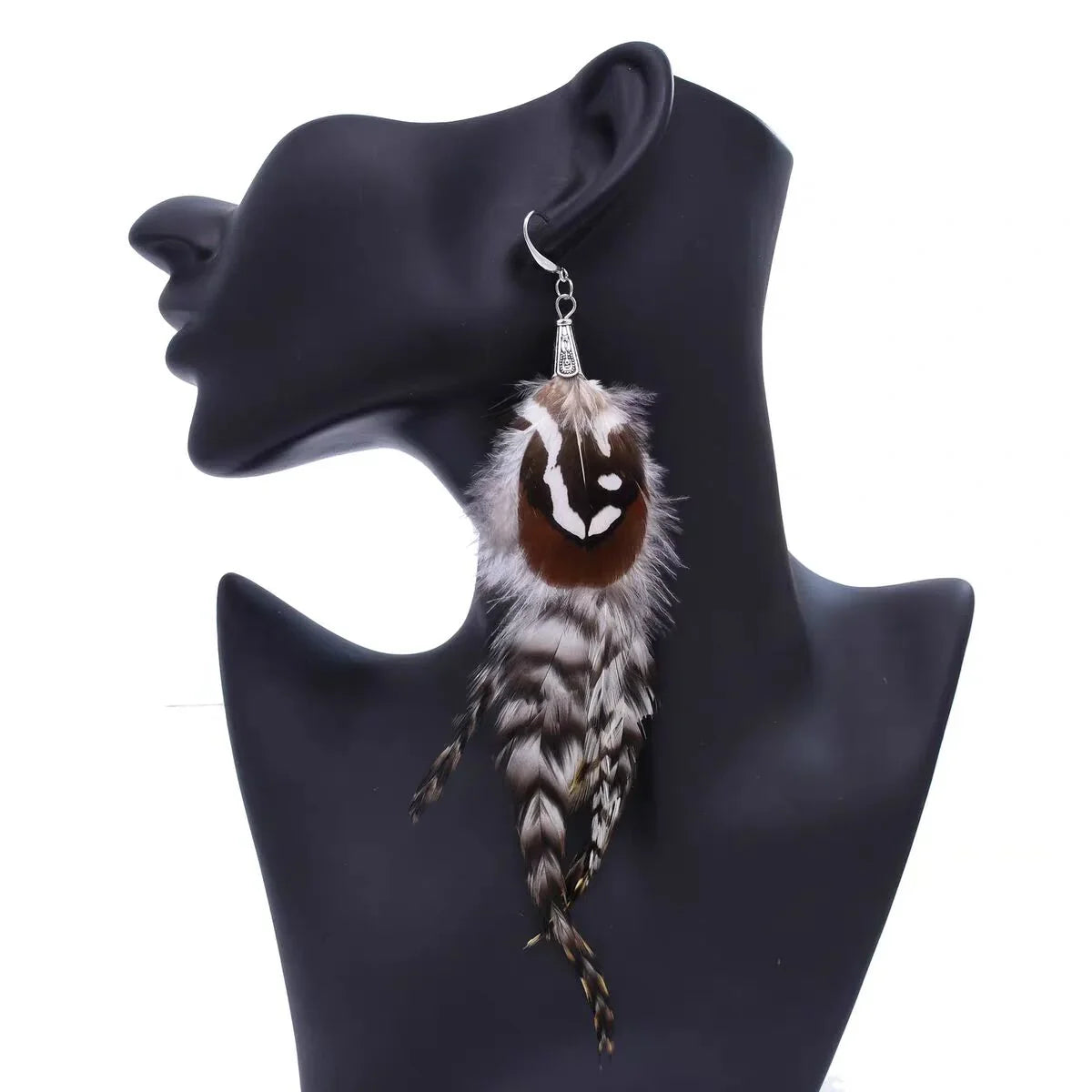 Bohemian style feather earrings on a black mannequin head