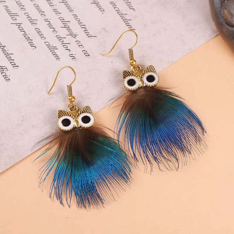 Pair of gold owl earrings featuring brown and blue iridescent feathers