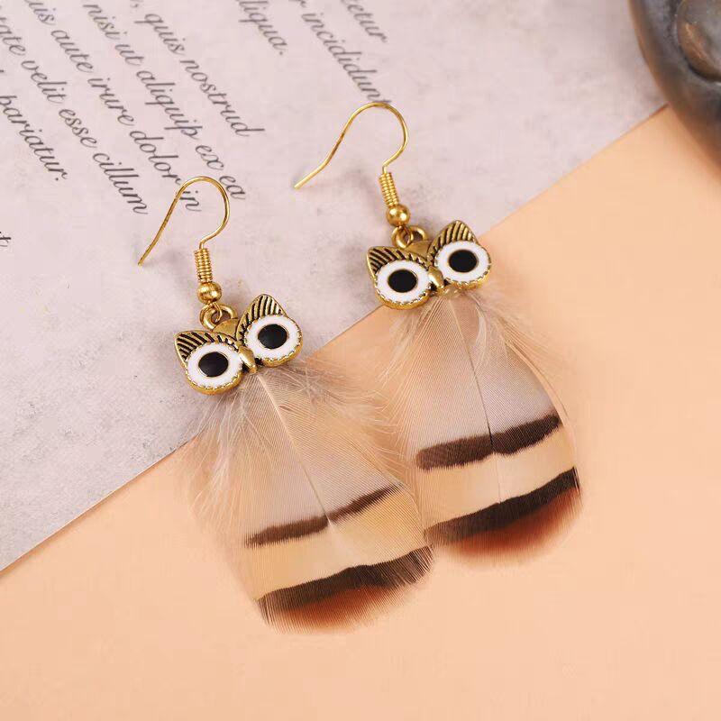 Gold owl-shaped earrings with natural brown and tan feathers