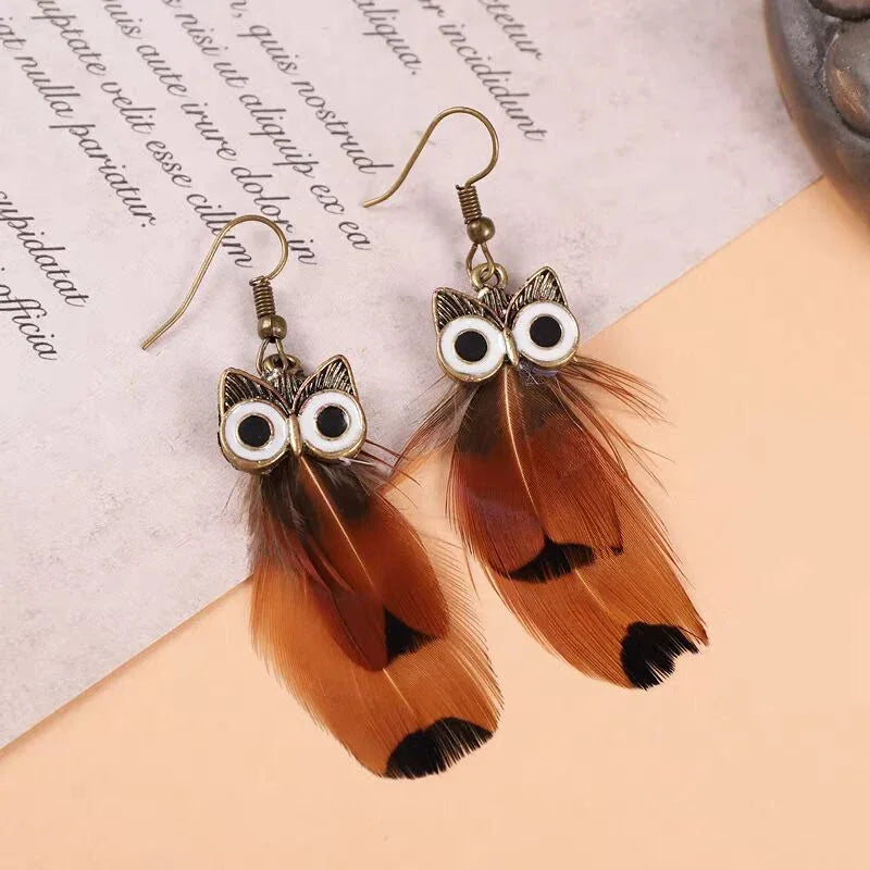 Pair of owl-shaped earrings with brown feathers and gold-tone hardware.