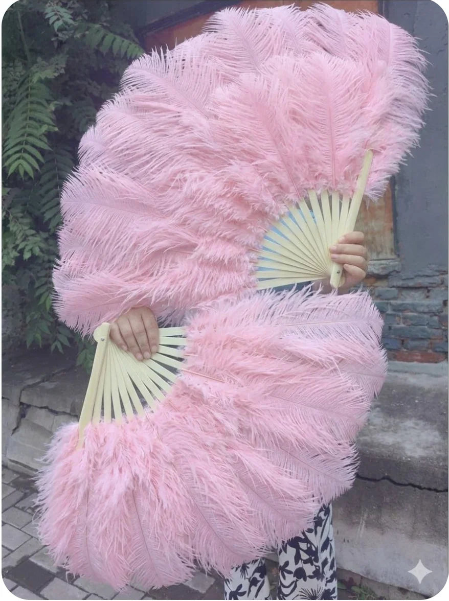 A pair of large baby pink Ostrich Feather Fans for burlesque dancing and stage performance.