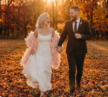 Load image into Gallery viewer, Blush pink ostrich feather shawl, lifestyle shot of the feather cape paired with a wedding dress for romantic photos
