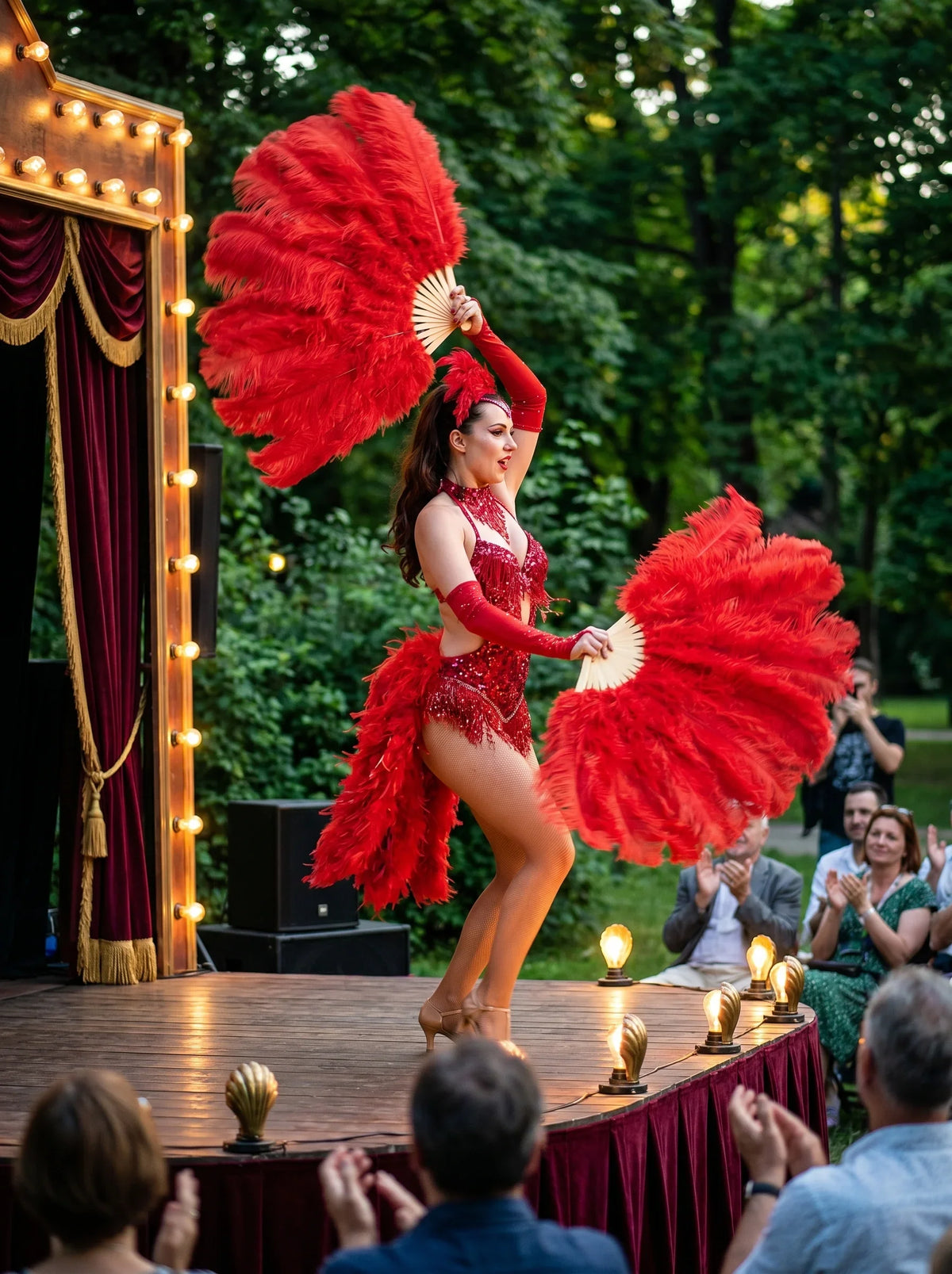 Red ostrich feather fans held by a burlesque dancer at an outdoor stage