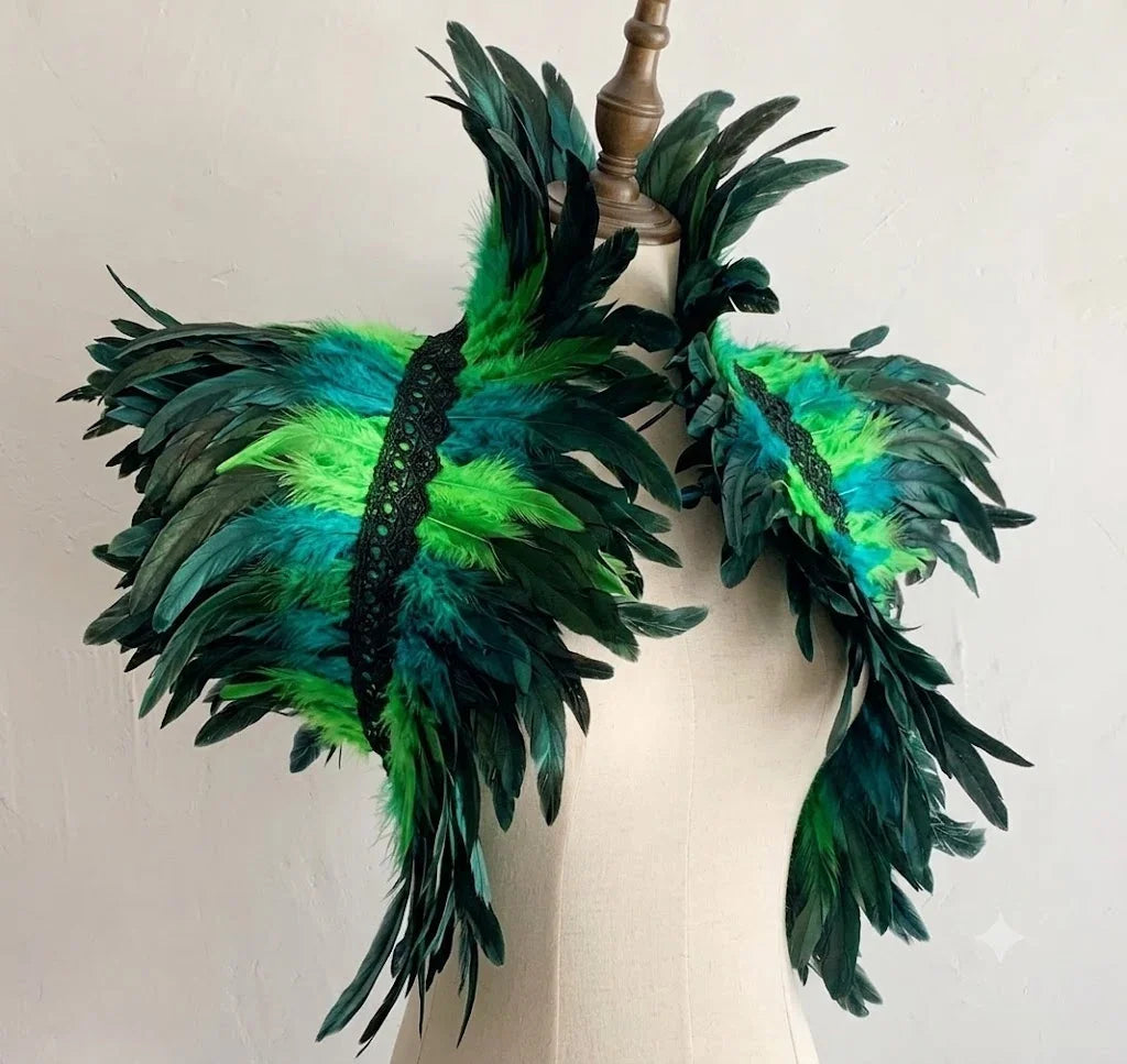 A vibrant emerald green layered feather capelet shrug showcased on a mannequin