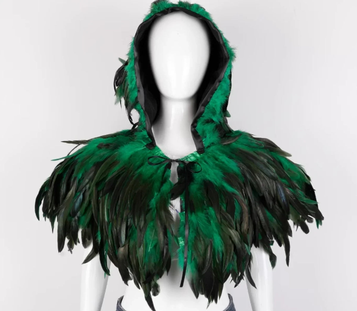 Green feathered hood on a mannequin against a white background