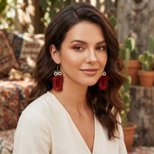 Load image into Gallery viewer, Model showcasing handmade long feather earrings in rich tones
