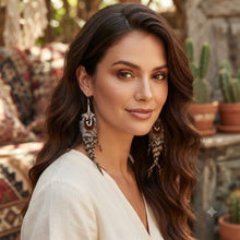 Load image into Gallery viewer, Handmade natural speckled feather dangle earrings worn by a model, bohemian style jewelry
