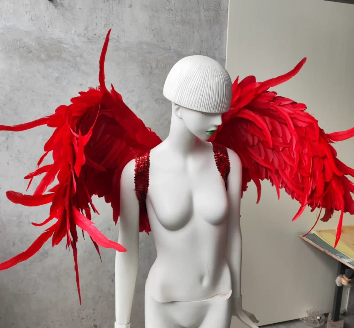 Large red feather devil wings, dramatic costume prop for Halloween, cosplay and photoshoots