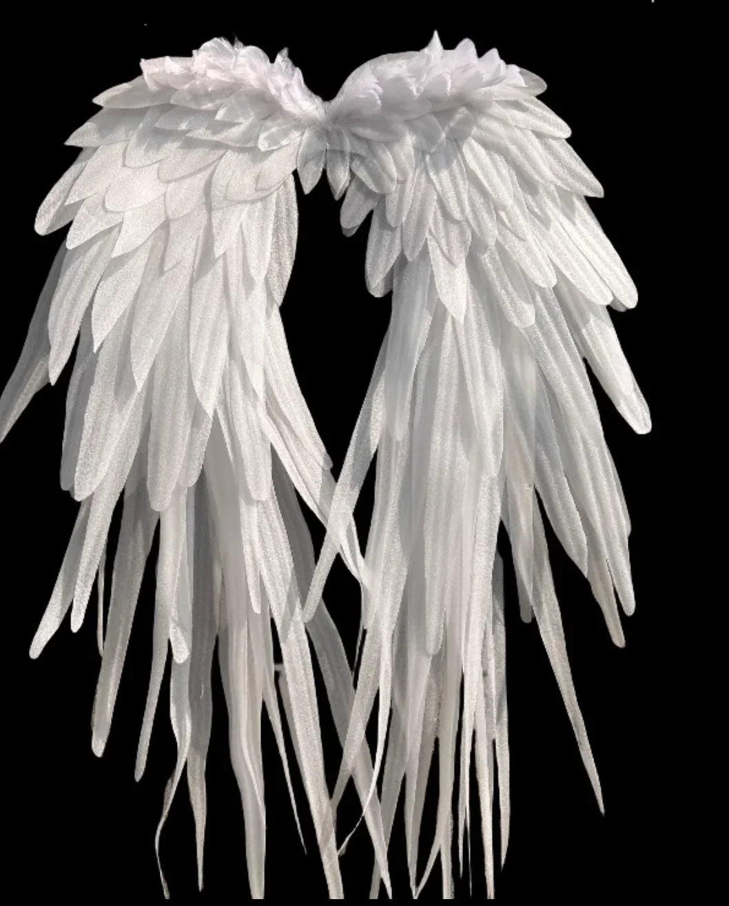 Oversized white feather angel wings on black background, dramatic costume wings for photoshoots, cosplay and events.