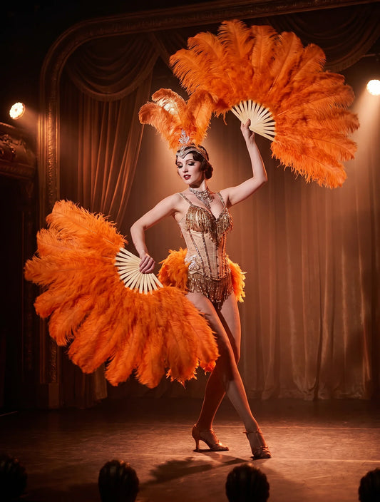 Orange ostrich feather fans held by a burlesque dancer on stage