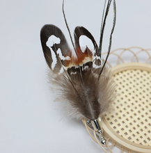 Load image into Gallery viewer, Feathered hair accessory on a white background
