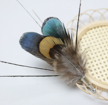 Load image into Gallery viewer, Feathers with blue, green, and yellow colors on a white background
