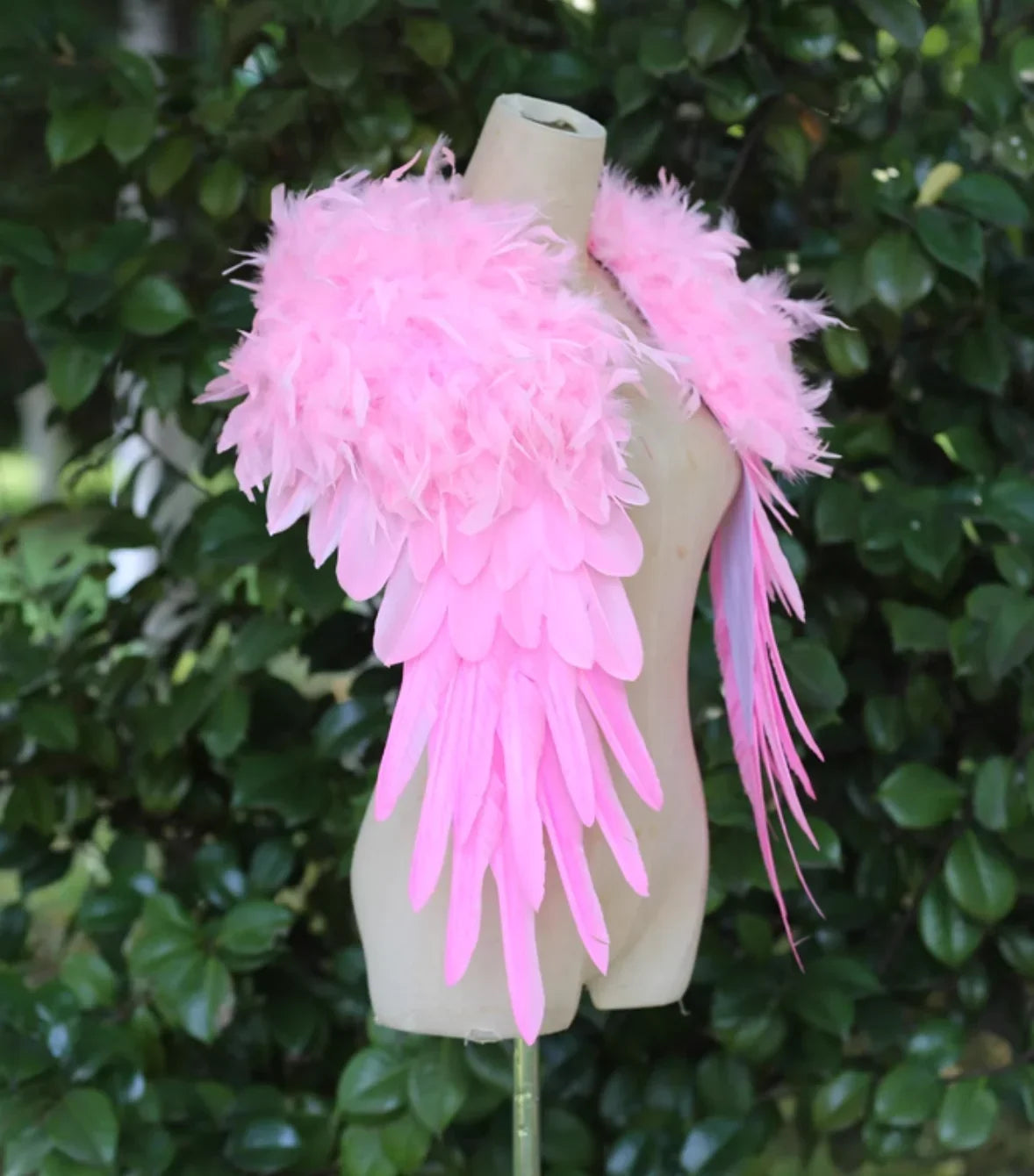 Soft pink feather wings displayed on a mannequin, perfect for costume parties, photoshoots, and stage performances.