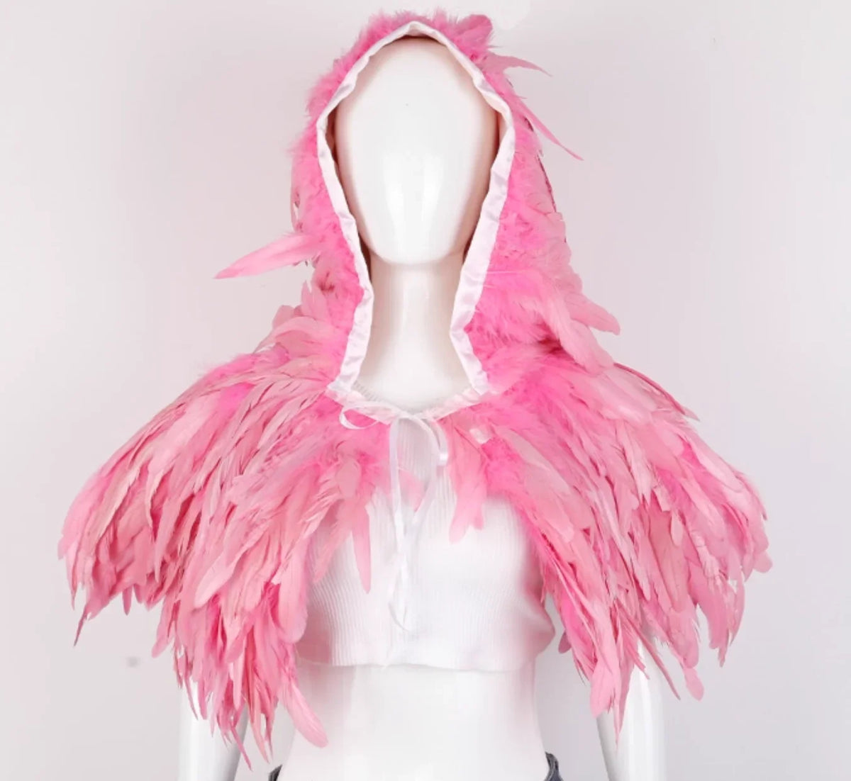 Mannequin wearing a pink feathered hood against a light gray background