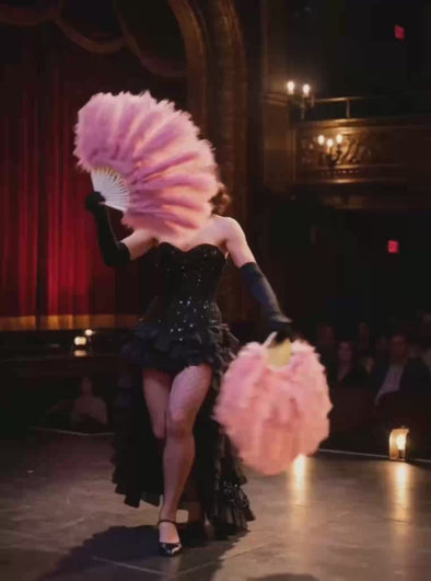 A video demonstration of a large ostrich feather fan being used in a burlesque dance routine.