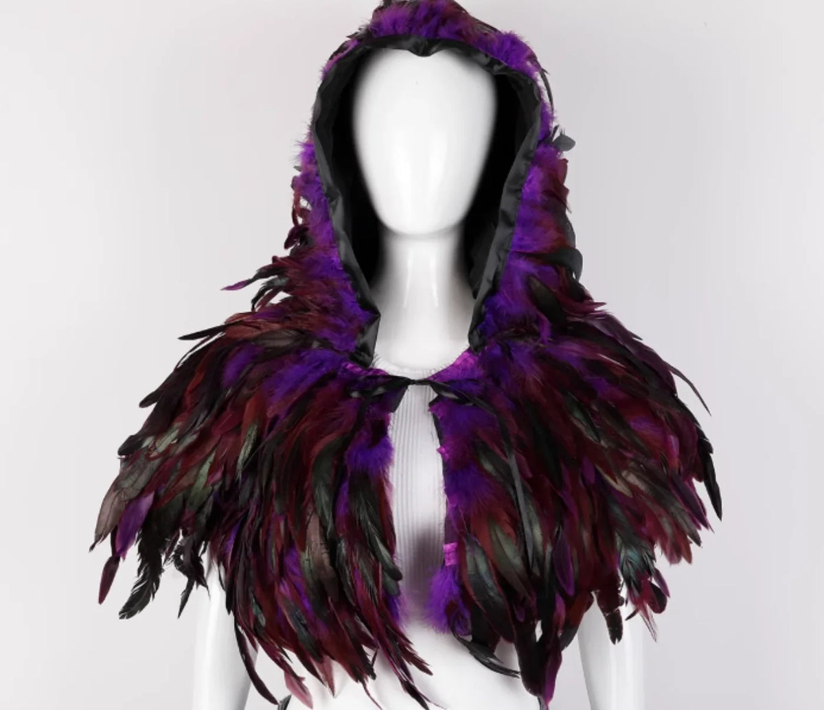 Purple feathered hood on a mannequin against a white background