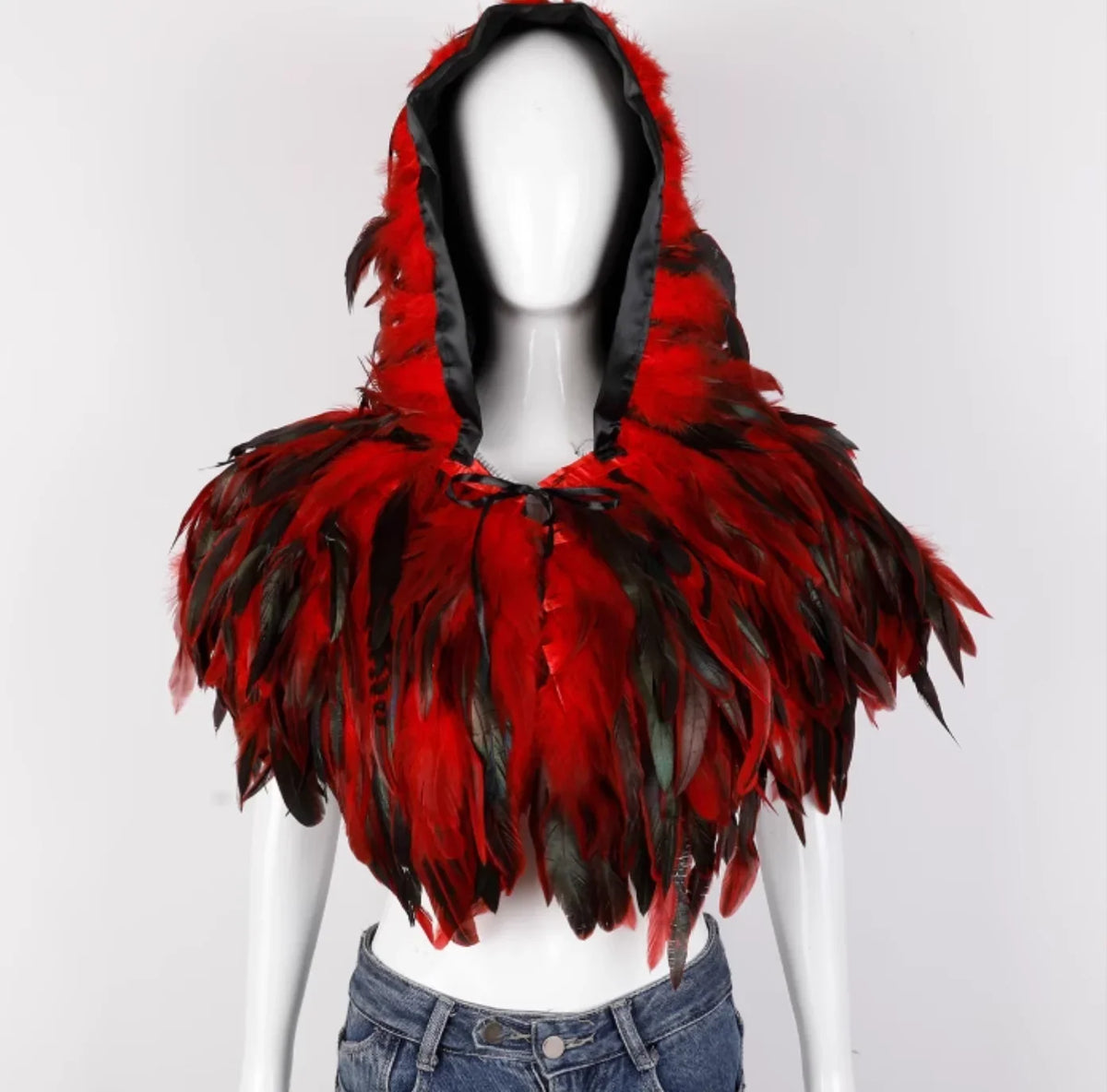 Red and black feathered hood on a mannequin against a white background