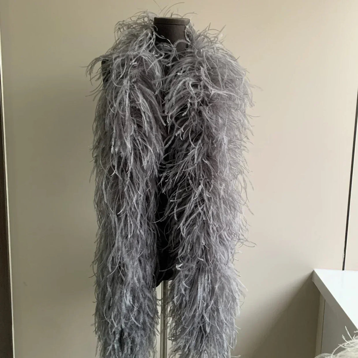 Grey ostrich feather boa displayed on a mannequin