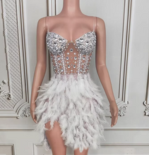 Load image into Gallery viewer, Mannequin wearing a silver sequin and feather dress against a decorative wall.
