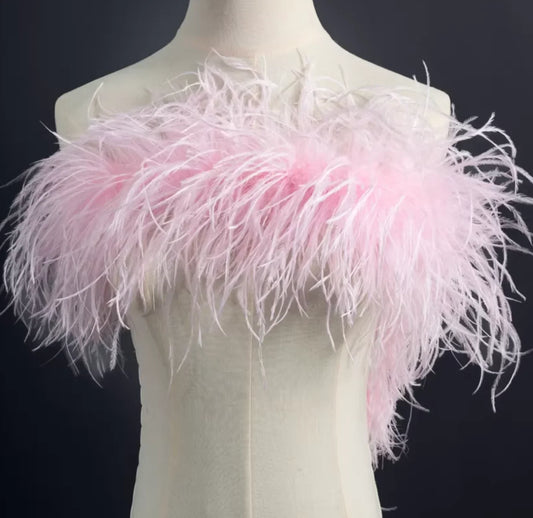 Model wearing a baby pink ostrich feather boa for a vintage 1920s Gatsby party or burlesque performance.
