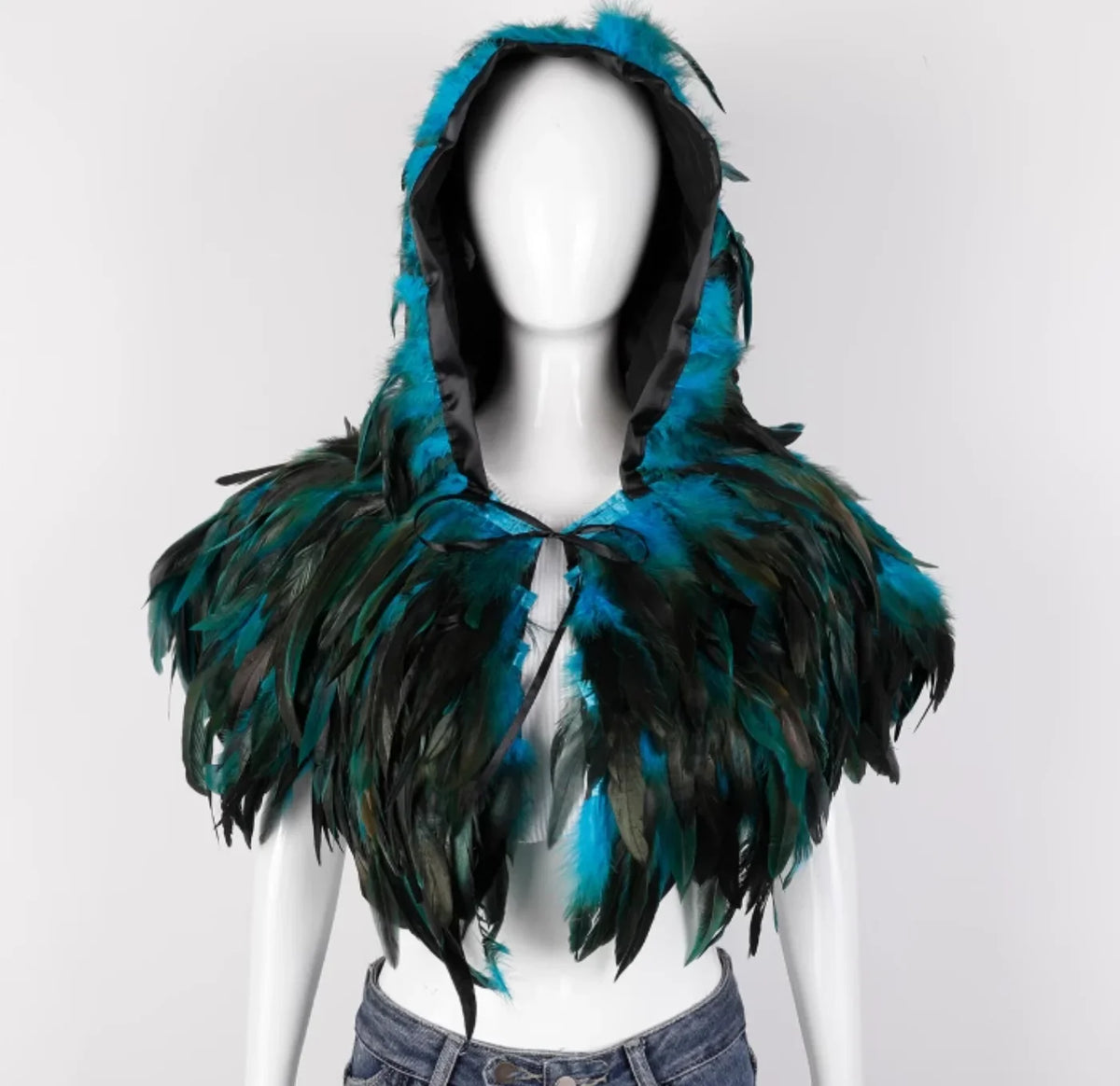 Mannequin wearing a teal and black feathered hood on a white background