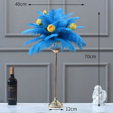 Load image into Gallery viewer, Tall wedding centerpiece featuring turquoise ostrich feathers in a gold Eiffel Tower vase for a luxury reception.

