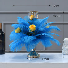 Load image into Gallery viewer, Tall wedding centerpiece featuring turquoise ostrich feathers in a gold Eiffel Tower vase for a luxury reception.
