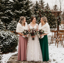 Load image into Gallery viewer, Three bridesmaids in forest green dresses wearing white faux fur stoles with brown tips for a winter wedding.
