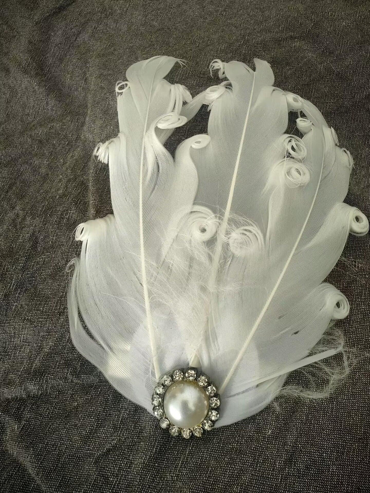 white feather hair pin, showcasing soft feathers and pearl accent for formal events