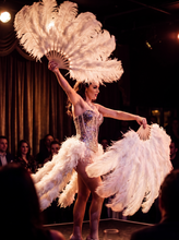 Load image into Gallery viewer, White ostrich feather fans held by a burlesque dancer on stage
