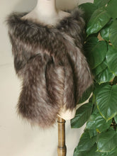 Load image into Gallery viewer, A deep grey faux fur bridal wrap displayed on a mannequin bust, with a green potted plant beside it.
